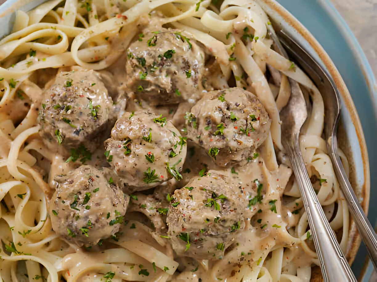 Easy Garlic Butter Meatballs served over creamy Parmesan linguine