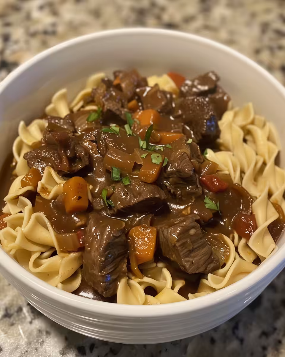 Ingredients laid out for crockpot beef and noodles recipe including seasoning packets and beef