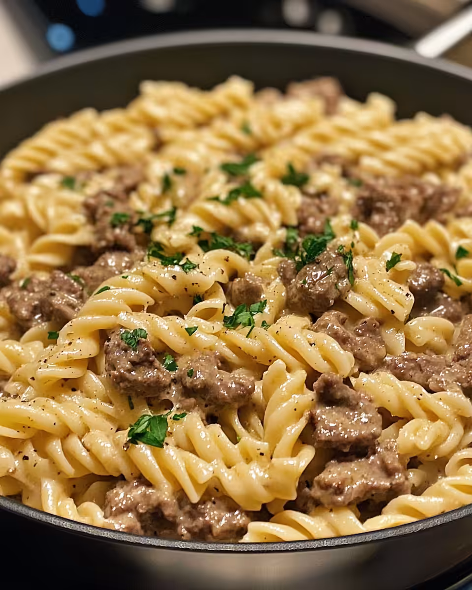 Creamy garlic butter beef pasta served with fresh parsley garnish