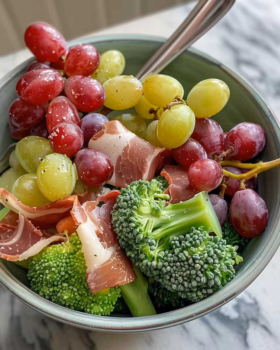 Freshly tossed broccoli grape salad ready to serve