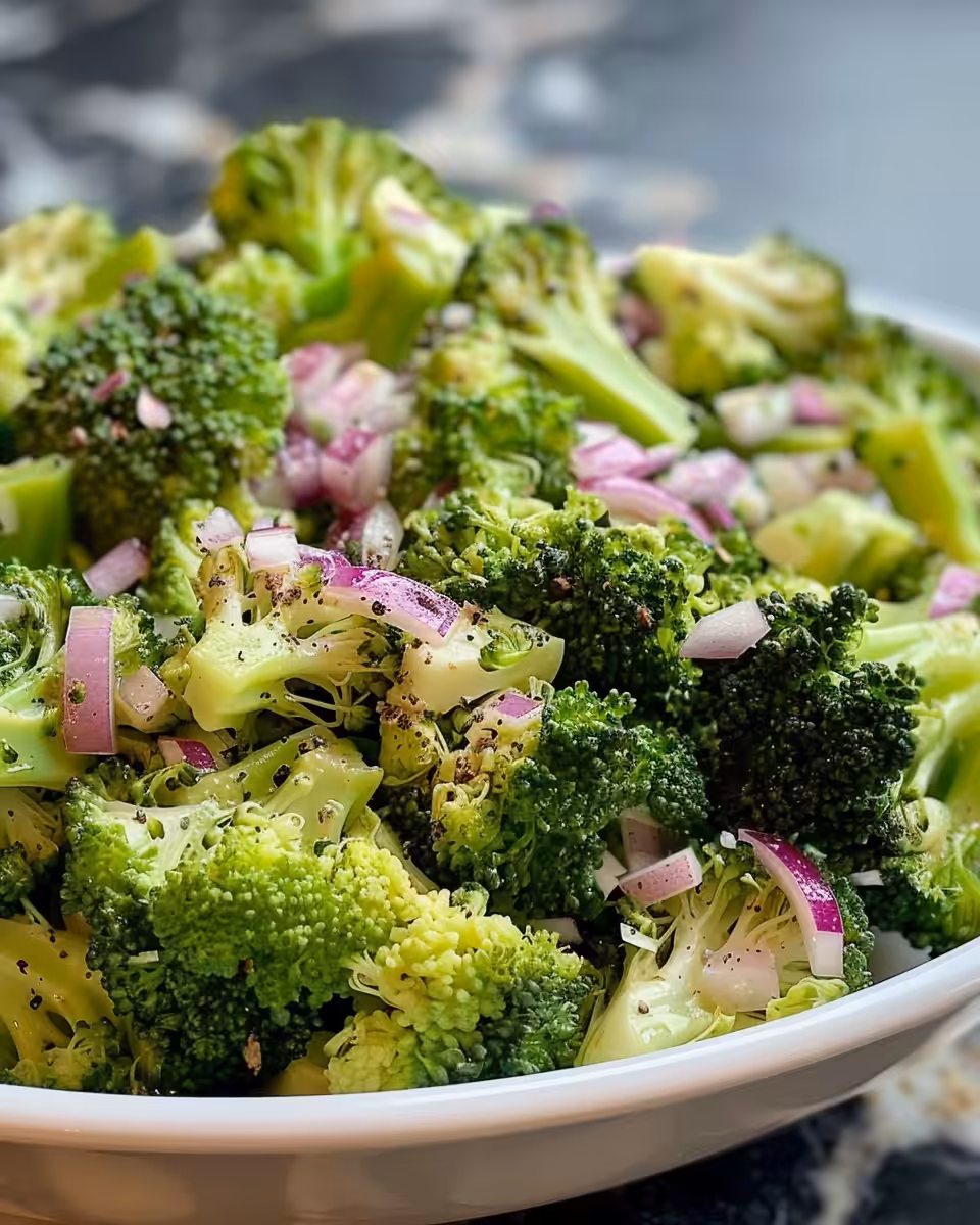 Broccoli salad mixed and ready to chill in a bowl
